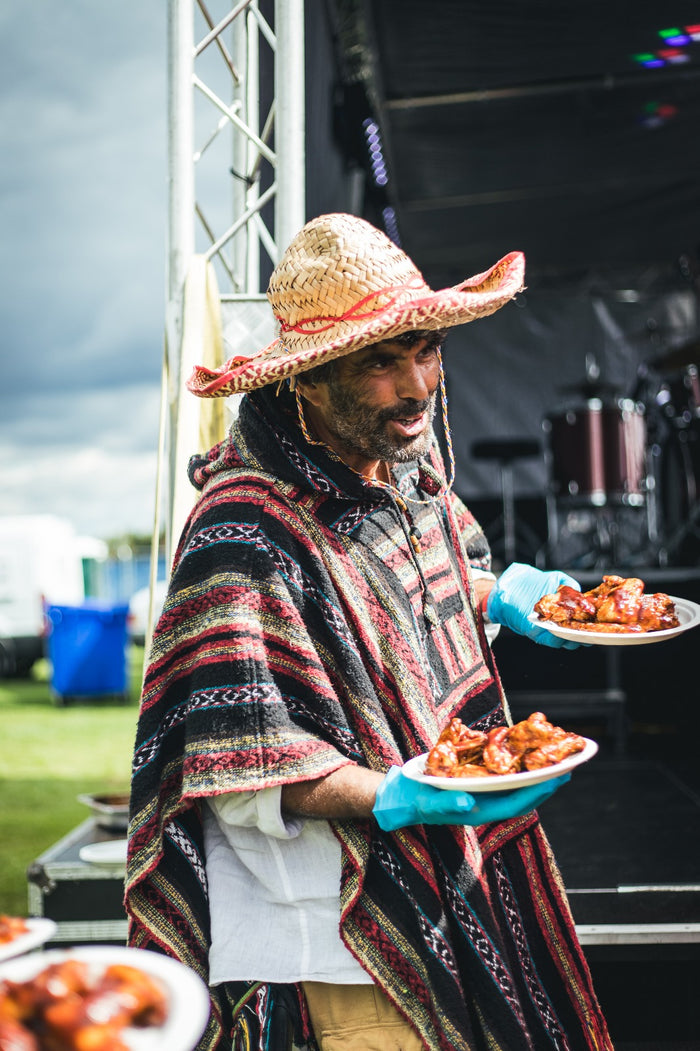 Tray of spicy chicken wings coated in hot sauce at outdoor food stall