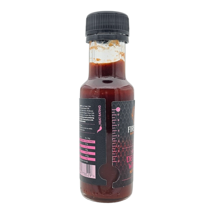 Black cap hot sauce bottle with red liquid inside