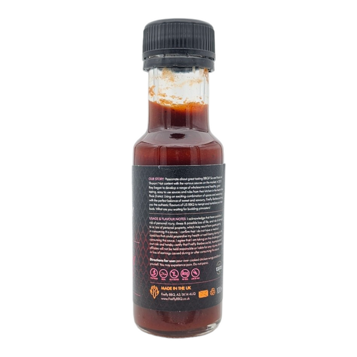 Black cap hot sauce bottle with red liquid inside