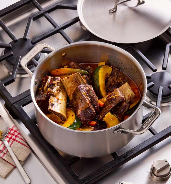 Braised beef short ribs with vegetables in Misen stainless steel pot on gas stove