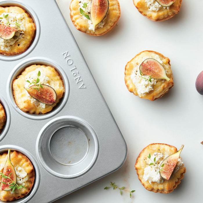 Styled hero shot: for baking muffins and cupcakes – alumised steel – Anolon Pro-Bake Muffin Pan 12 Cup
