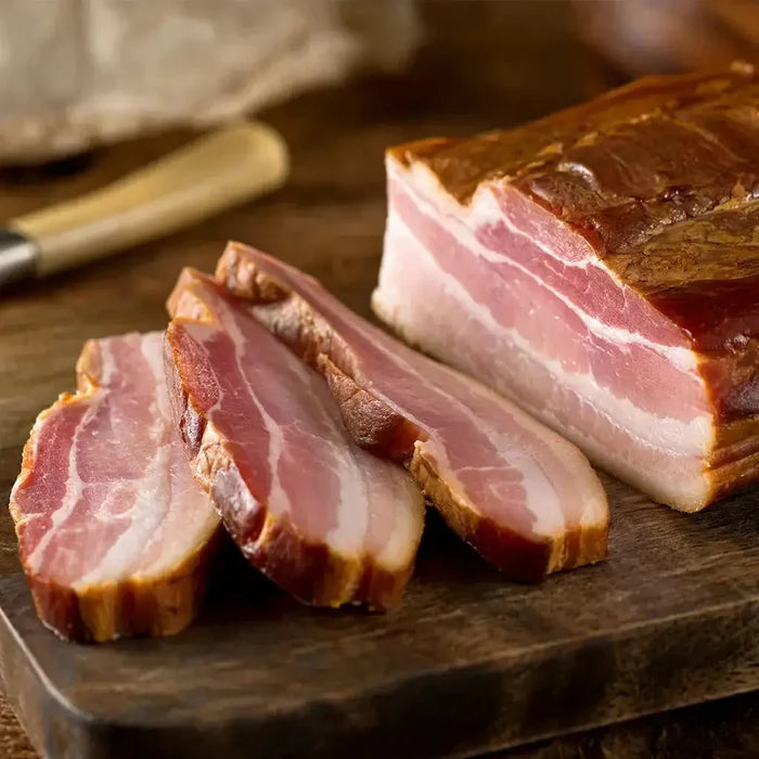 Sliced bacon with cured pork on wooden board