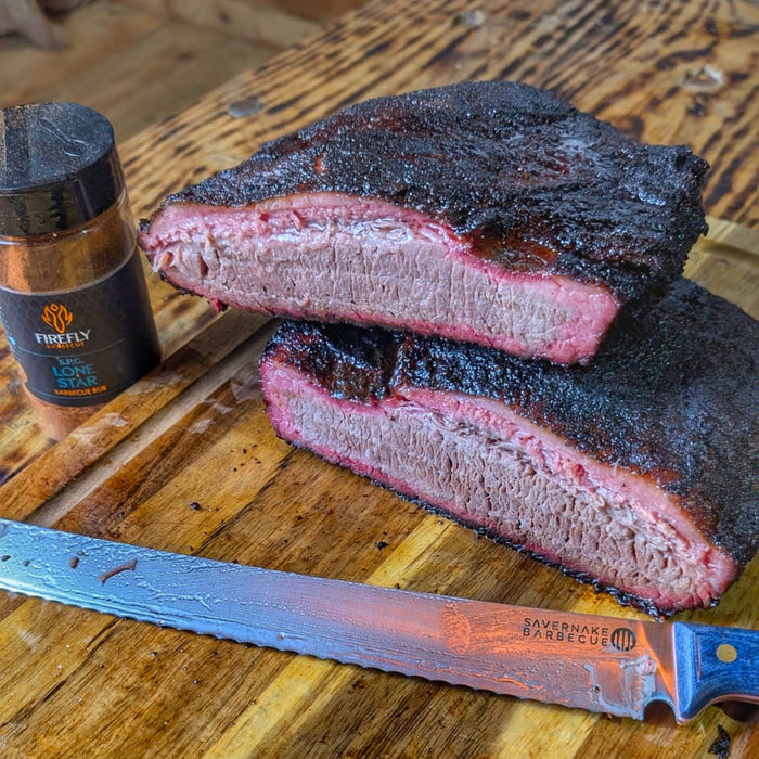 Smoked beef brisket with barbecue rub on wooden board