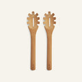 Two versatile Beechwood Serving Spoons with wide handles and pronged ends are shown side by side on a plain, light background.