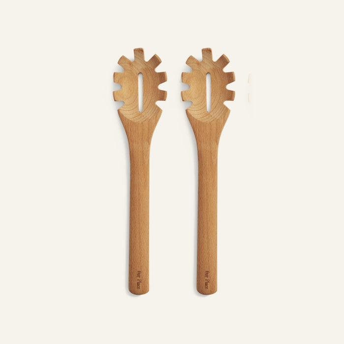 Two versatile Beechwood Serving Spoons with wide handles and pronged ends are shown side by side on a plain, light background.