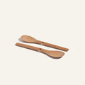 Two Beechwood Spoons with flat handles and center holes are placed side by side on a plain, light background.