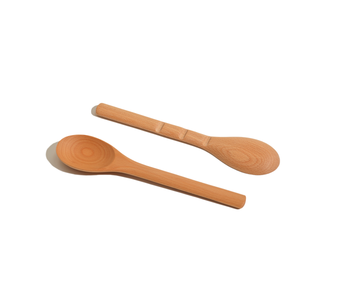 Two Beechwood Spoons with rounded bowls and smooth handles, classic kitchen utensils, are placed side by side on a white background.