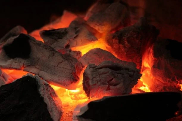 Glowing hot charcoal embers for outdoor grilling and barbecues
