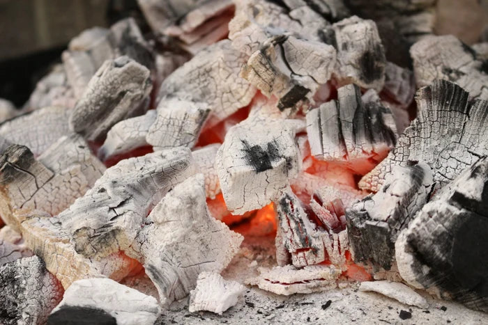Glowing hot charcoal embers for outdoor grilling and BBQ cooking
