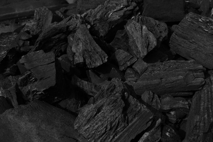 Black and white charcoal pieces for barbecue and outdoor grilling