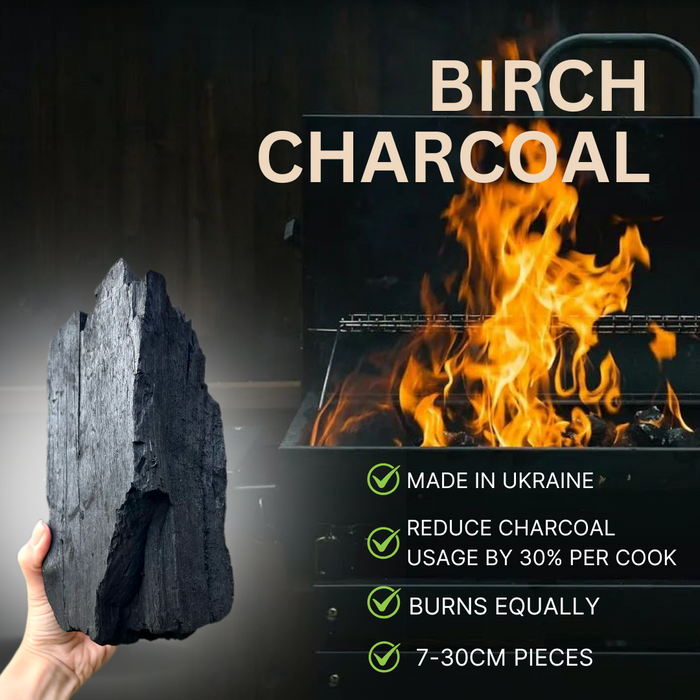 Burning charcoal on grill with flames, black background