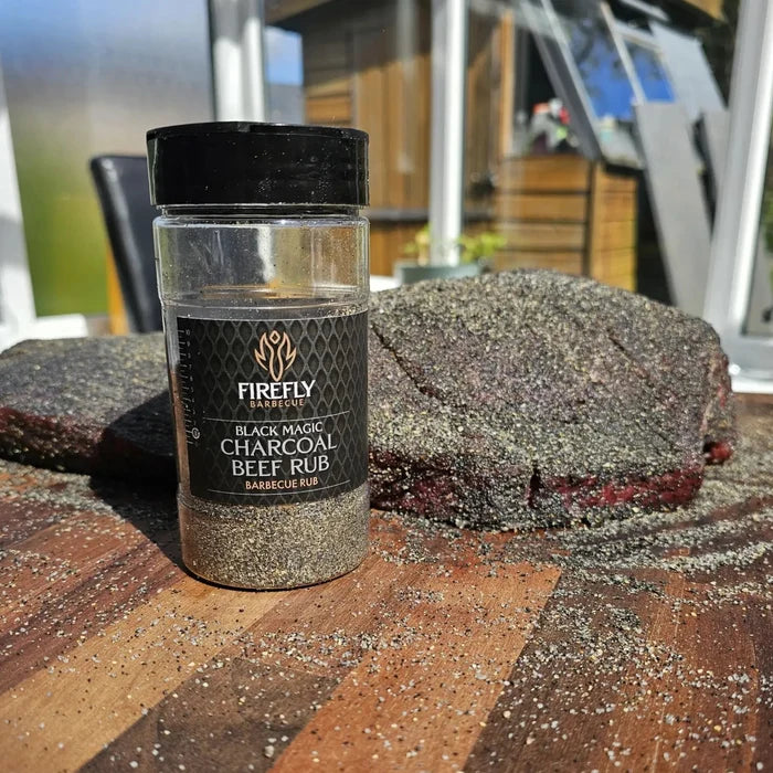 BBQ seasoning jar with smoked beef on wooden table