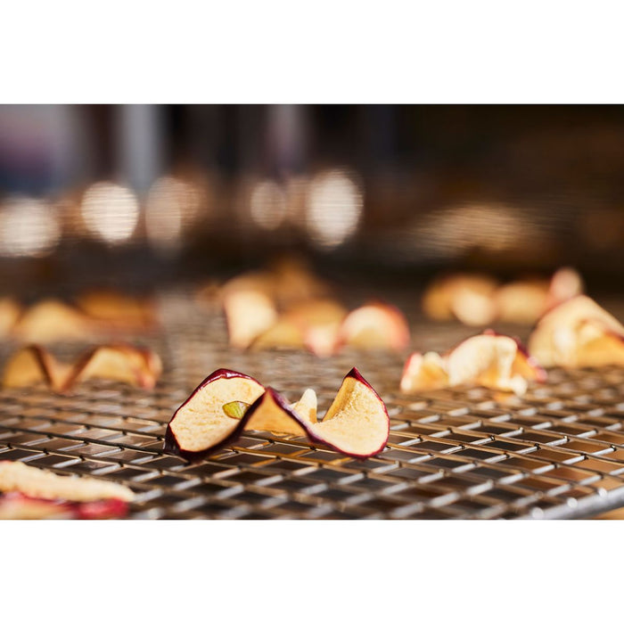 Close-up of baked apple slices on stainless steel grill rack