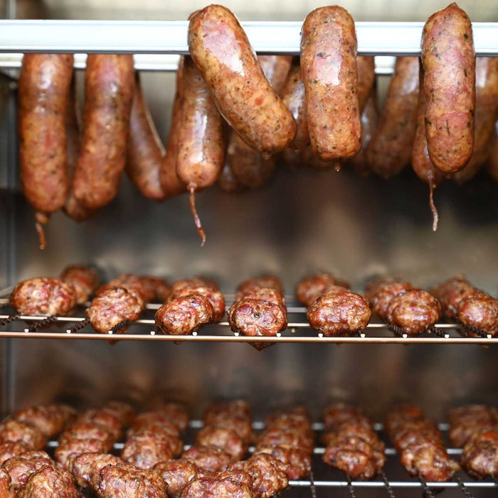 Cooked sausages on smoker grate in oven