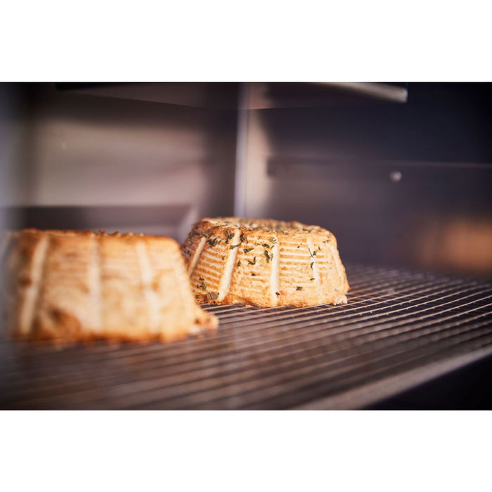 Baked apple slices on stainless steel grill rack in oven