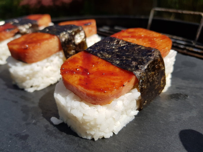 Spam musubi topped with California Apple BBQ Sauce, adding a sweet California twist to this grilled rice and seaweed snack.