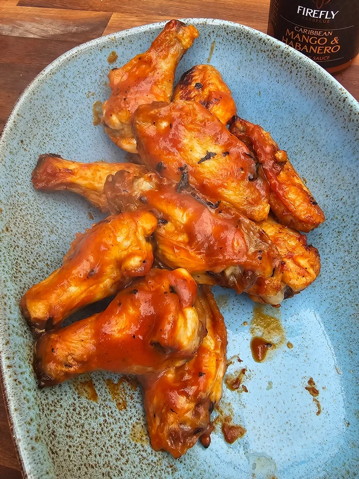 Bottle of Caribbean Mango Habanero BBQ sauce with black cap
