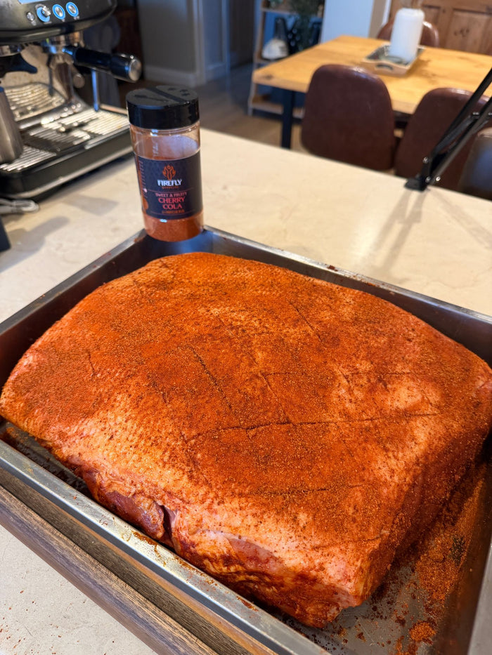 Barbecue seasoned meat with Cherry Cola BBQ Rub on tray