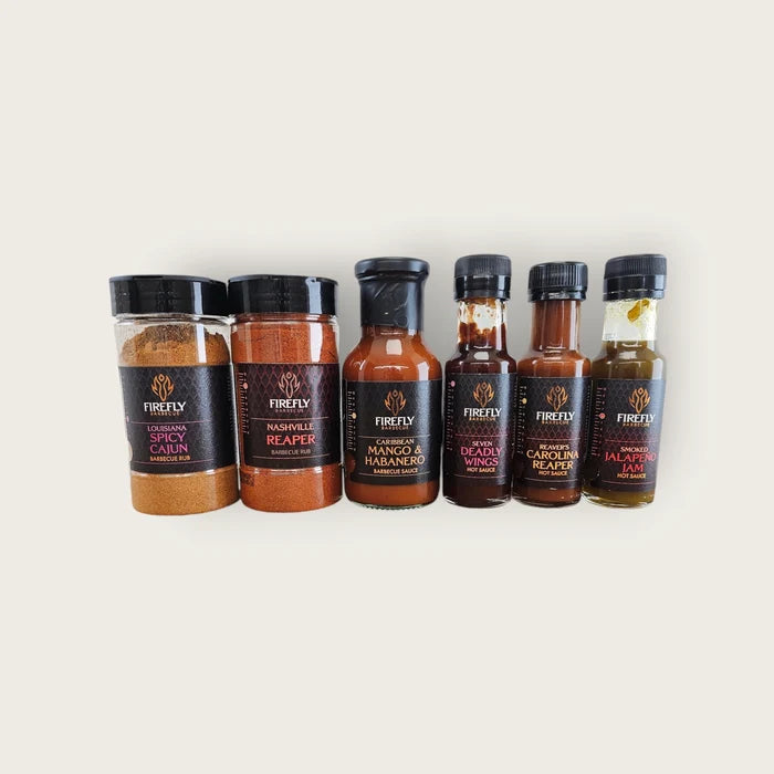 Hot Shots - Chilli Sauces and Rubs Kit featuring 6 award-winning spice blends and sauces including Carolina Reaper and Mango Habanero. Ideal gift set for BBQ lovers.