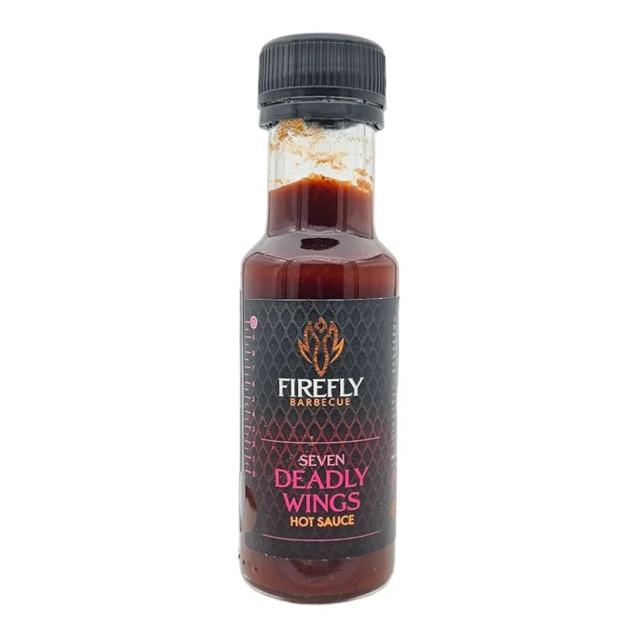 Black cap hot sauce bottle with red liquid inside