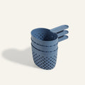 Three blue plastic Cooker Cups with perforated holes, stacked together on a light background—ideal for cooking three things at once and the perfect multi-purpose companion to your Perfect Pot.
