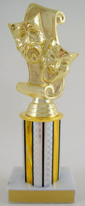 A gold-colored trophy featuring three classical theater masks (comedy, tragedy, and drama) on a scroll-like top, mounted on a striped gold and iridescent column over a white and gold base.