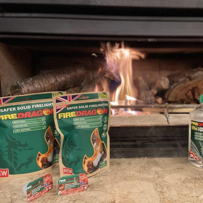FireDragon firelighter pouches in front of a fireplace with flames