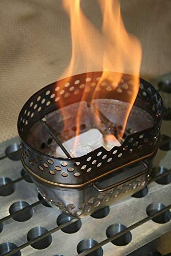 Firelighter in use igniting charcoal with flames
