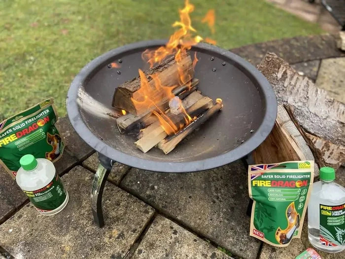 Outdoor fire pit with burning wood and FireDragon firelighter products, eco-friendly firelighting