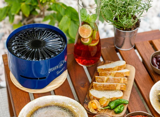 Outdoor table setting with Feuerhand Tamber Table Top Grill in use