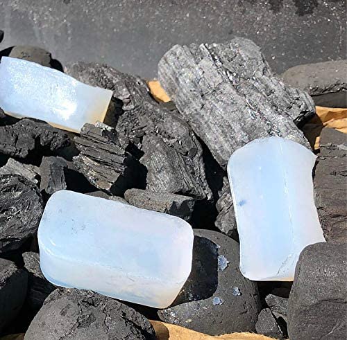 White solid fuel firelighters on black rocks for outdoor fire lighting