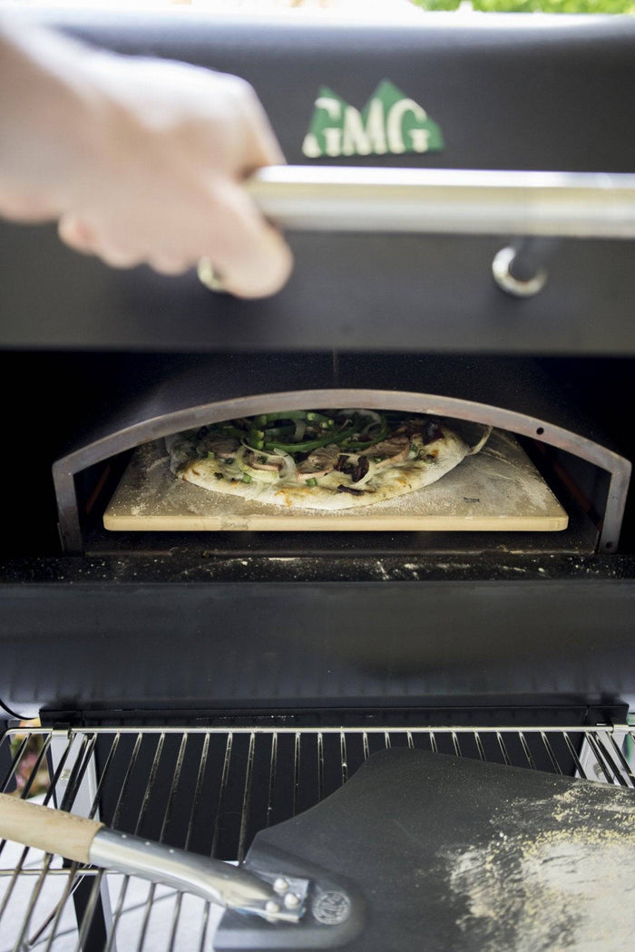 Pizza cooking inside GMG Trek outdoor pizza oven