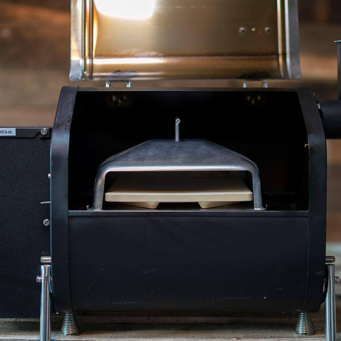 GMG Wood-Fired Pizza Attachment installed inside a GMG pellet grill, showcasing its compact fit and dual-layer stone design for even cooking.