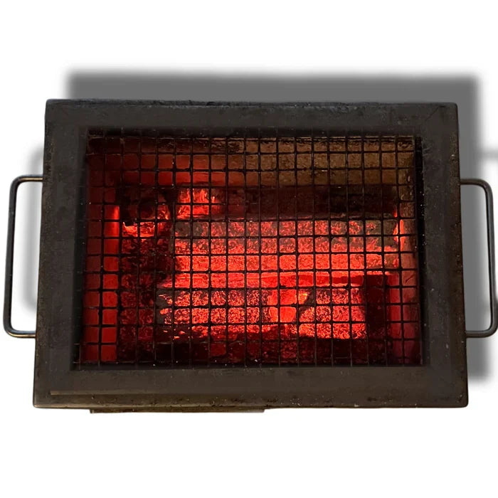 Red hot charcoal briquettes in grill for outdoor barbecue