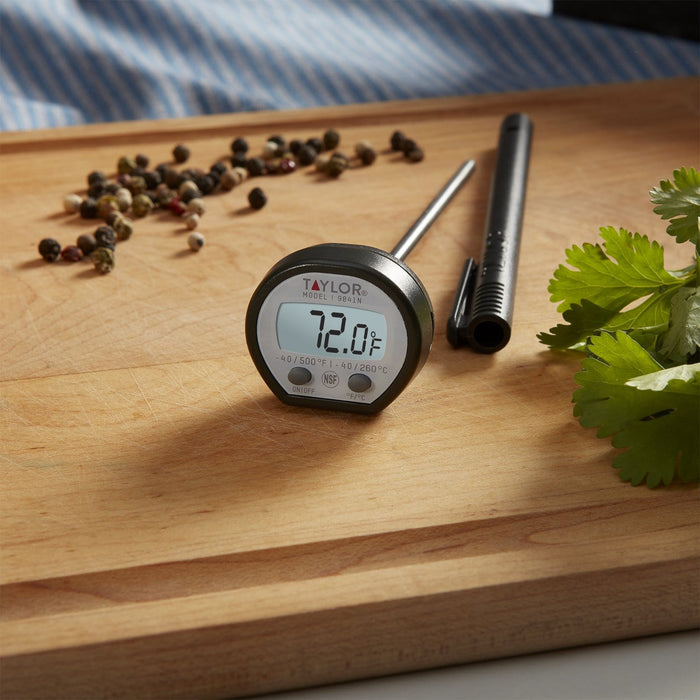 High Temp Instant Read Thermometer on a wooden cutting board with mixed peppercorns and fresh parsley.