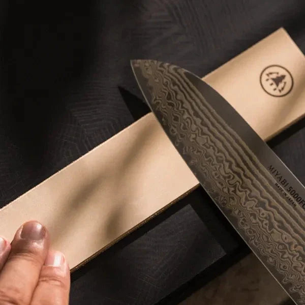 Damascus steel knife with Horl leather sharpening stone for precise finishing