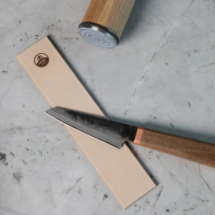 Horl leather sharpening stone with logo and knife for precise edge finishing