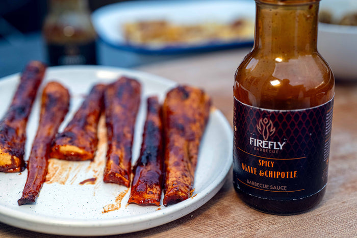 Barbecue sauce bottle with grilled meat and sauce
