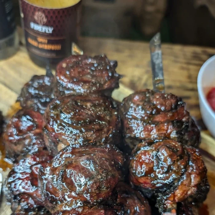 Barbecue sauce bottle with grilled meat and sauce