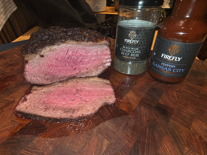 Uncooked beef with Firefly Barbecue branding on butcher paper