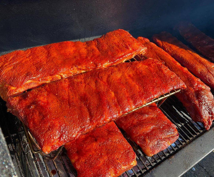 Grilled ribs with BBQ sauce on grill