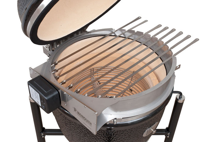 Monolith LeChef Rotisserie skewers installed on ceramic grill with rotisserie ring and motor, perfect for outdoor barbecue cooking.
