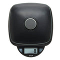 Close-up of a black digital kitchen scale showing a large brushed metal circular control on the top