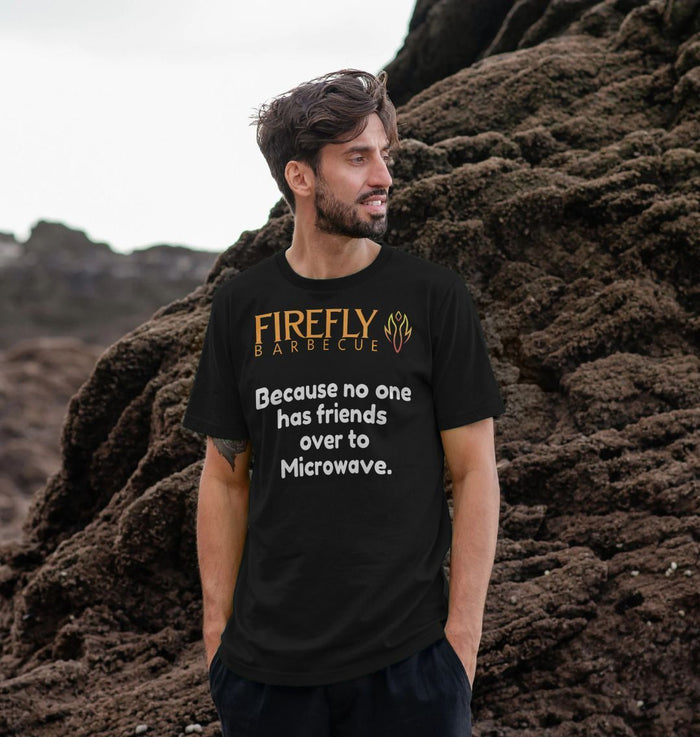 Male model wearing black 'Friends Over to Microwave' T-shirt outdoors for casual fashion