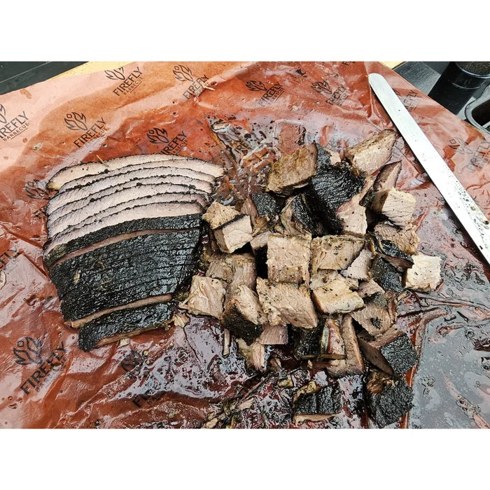 Smoked meat wrapped in pink butcher paper
