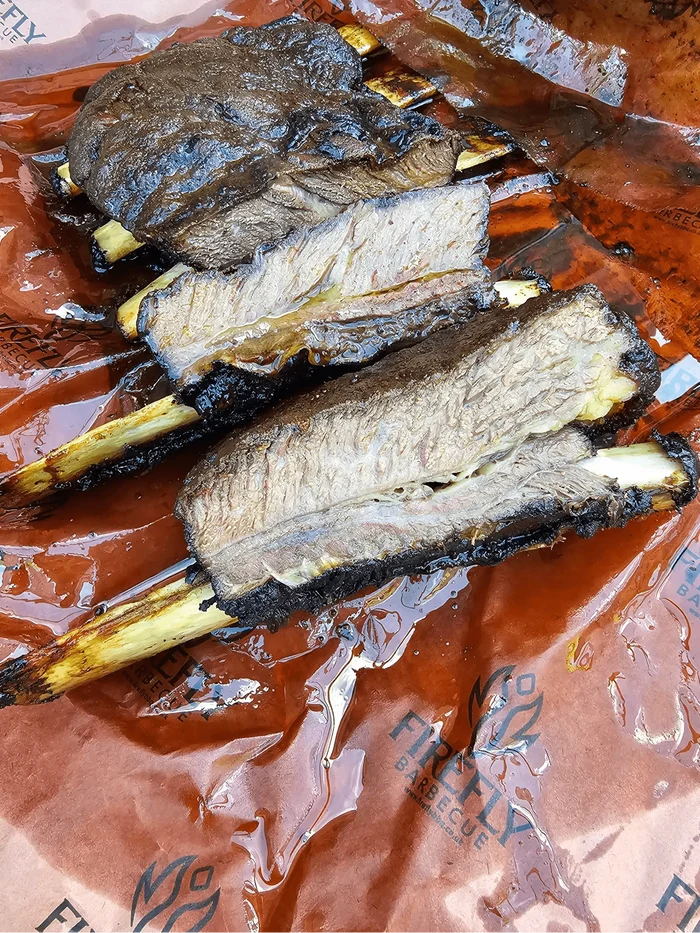 Smoked beef ribs on Oren Pink Butcher Paper BBQ - 61cm x 305m roll, showcasing juicy texture and bark preservation.