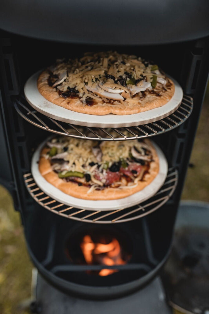Ozpig Oven Pizza Stone - Perfect Crusts | Easy Cooking. Two pizzas baking on Ozpig pizza stones inside a vertical smoker for crispy, evenly cooked bases.