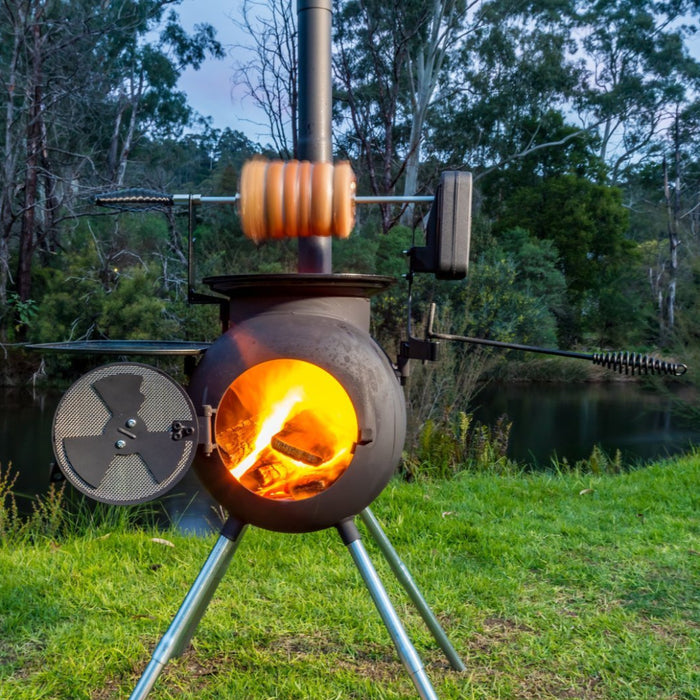 Ozpig Rotisserie Kit - FireFly Barbecue in use outdoors, roasting meat over open flame on Ozpig Series 2 for wood-fired cooking.