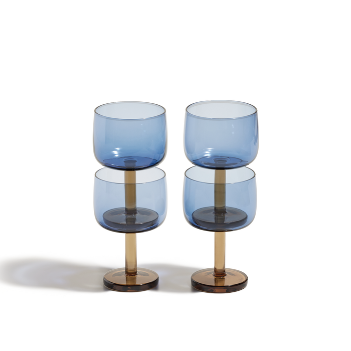 The Party Coupes set features four colourful coupes with blue-tinted bowls, gold stems, and brown bases arranged in two rows against a white background—ideal drinkware for your next celebration.