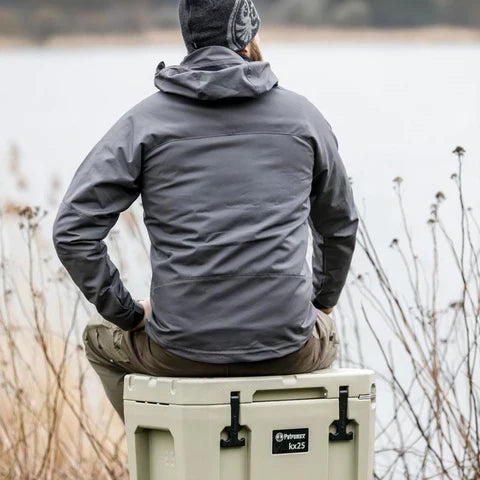 Person sitting outdoors with Petromax 25L Cool Box nearby